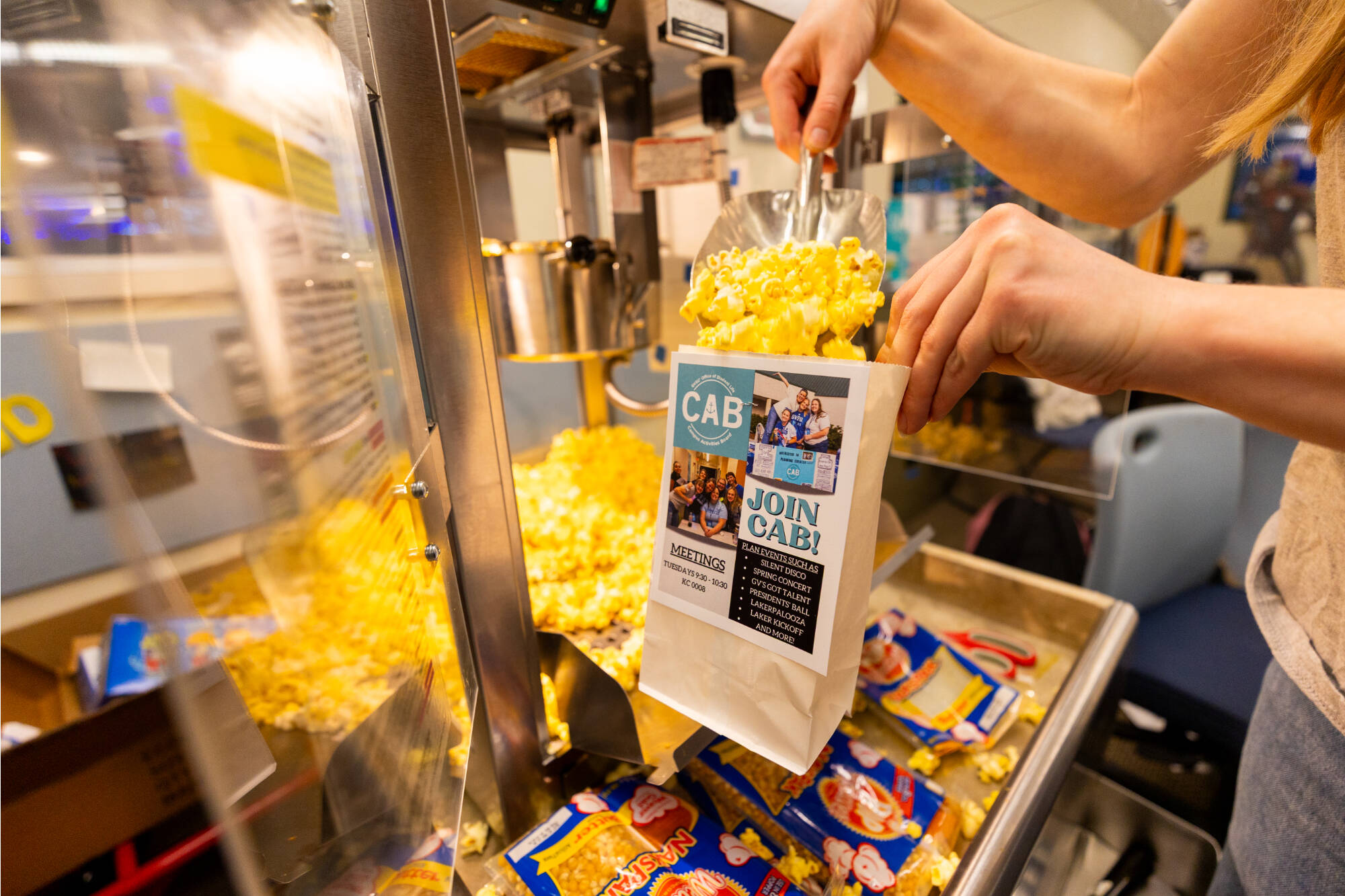 student filling popcorn bag